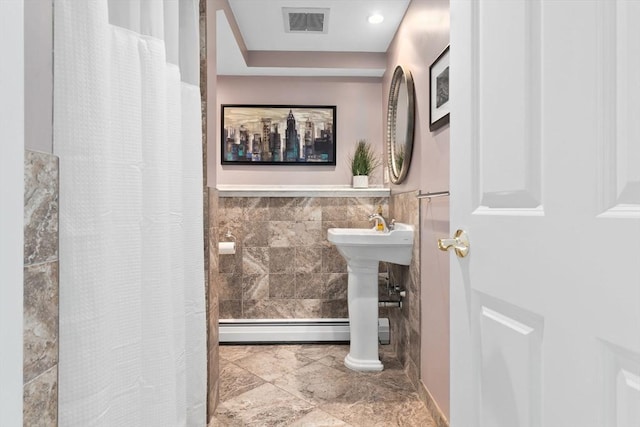 2 Cider Mill Rd, Peabody, MA 01960 - full bath featuring tile walls, a baseboard radiator, a shower with shower curtain, and wainscoting