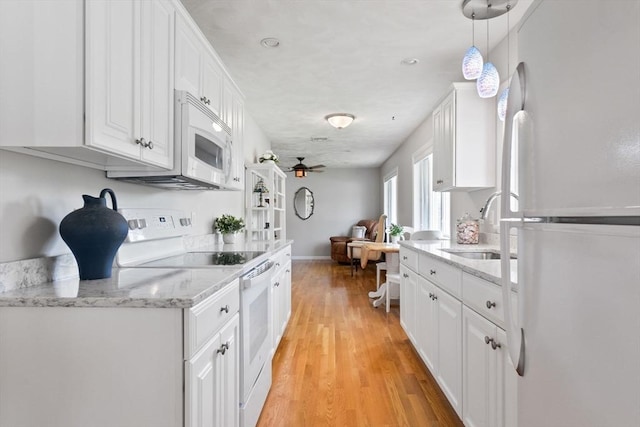 2 Cider Mill Rd, Peabody, MA 01960 - kitchen with white appliances, white cabinetry, a sink, light wood-type flooring, and open floor plan