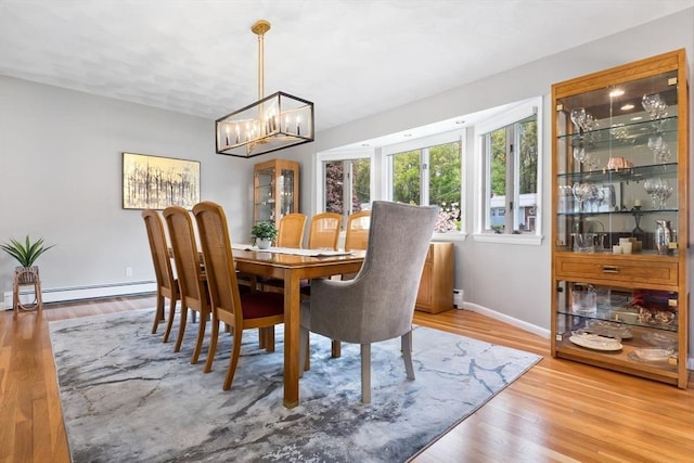 2 Cider Mill Rd, Peabody, MA 01960 - dining area with baseboard heating, a chandelier, baseboards, and light wood finished floors