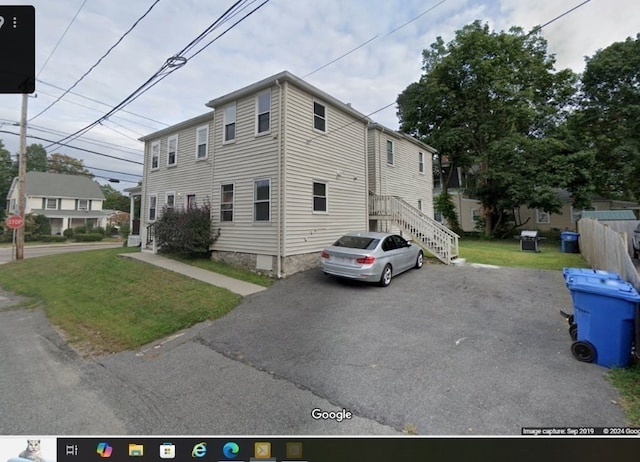 view of property exterior with a yard