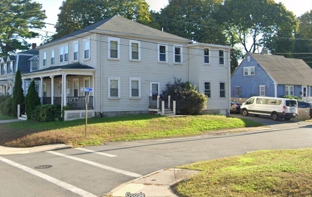 view of front of house with a porch and a front lawn