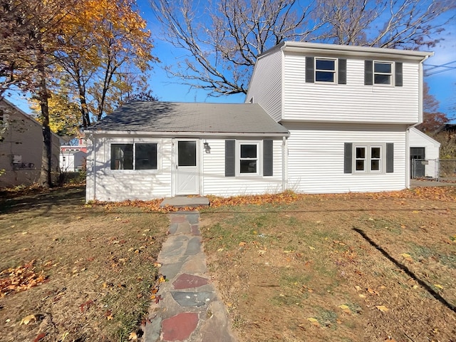 view of property featuring a front lawn