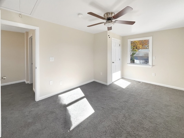 unfurnished bedroom featuring ceiling fan and dark colored carpet