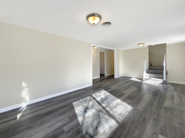 unfurnished living room with dark wood-type flooring