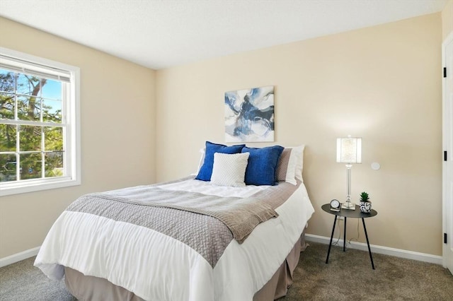 bedroom featuring carpet flooring and baseboards