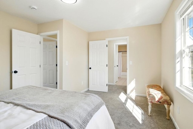 bedroom featuring light carpet and baseboards