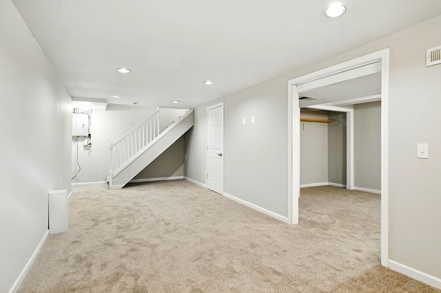 below grade area featuring carpet floors, stairway, and recessed lighting