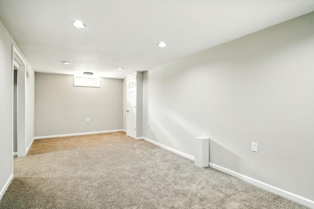 basement featuring carpet, baseboards, and recessed lighting