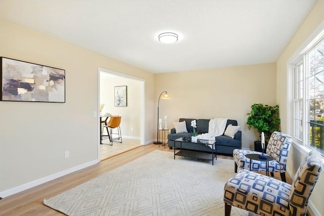 living room with light wood-style flooring and baseboards