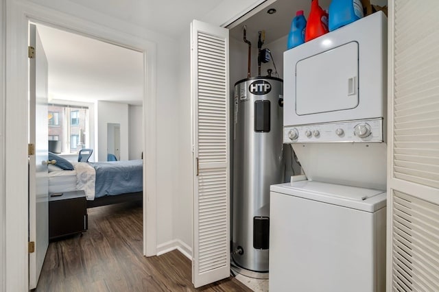 laundry room with dark hardwood / wood-style flooring, water heater, and stacked washer / dryer