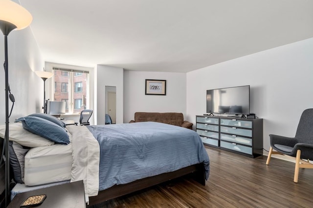 bedroom with dark hardwood / wood-style flooring