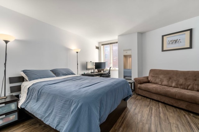 bedroom with dark hardwood / wood-style flooring