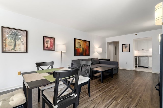 dining space with dark hardwood / wood-style flooring