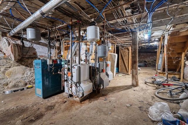 interior space featuring water heater and a heating unit