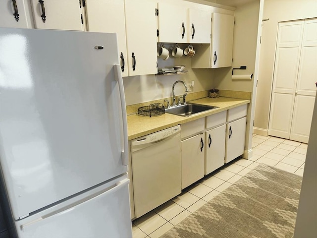 kitchen with white cabinets, white appliances, light countertops, and a sink