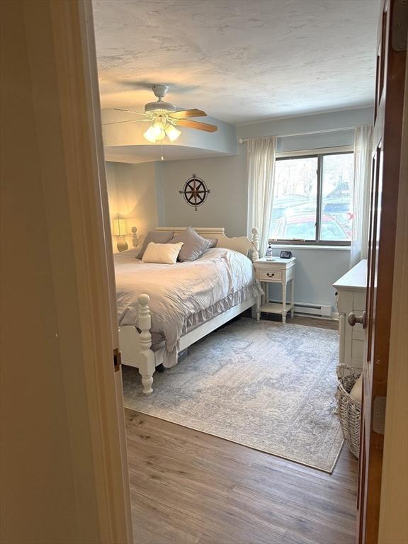 bedroom with ceiling fan and dark wood finished floors