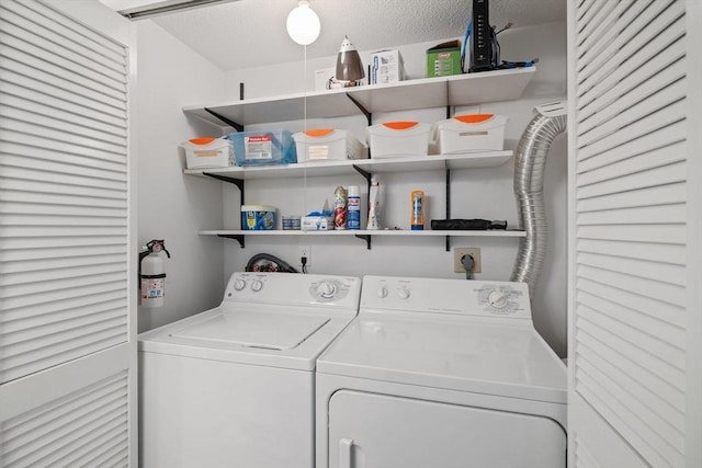 laundry room with laundry area, a textured ceiling, and washer and dryer