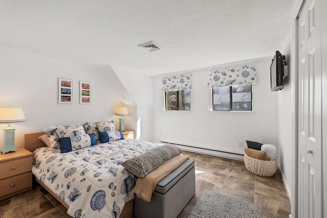bedroom with a closet, a textured ceiling, visible vents, and a baseboard radiator