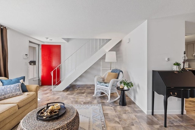 living room with a textured ceiling and stairway