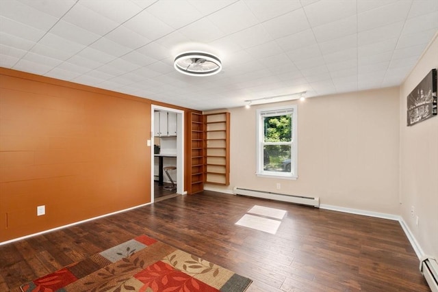 448 Washington St, Warren, MA 01083 - below grade area with a baseboard heating unit and wood finished floors