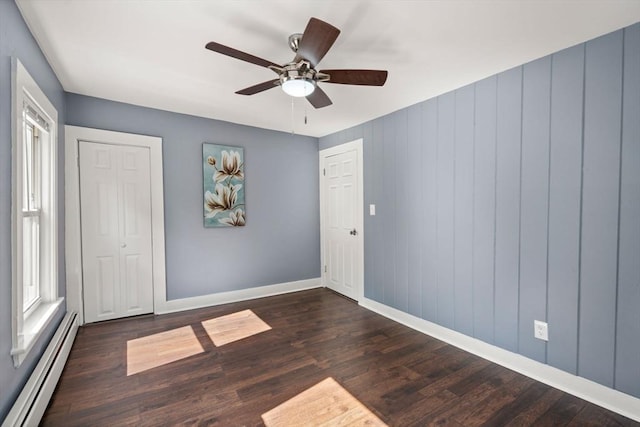 448 Washington St, Warren, MA 01083 - unfurnished bedroom featuring a baseboard radiator, wood finished floors, ceiling fan, and a closet