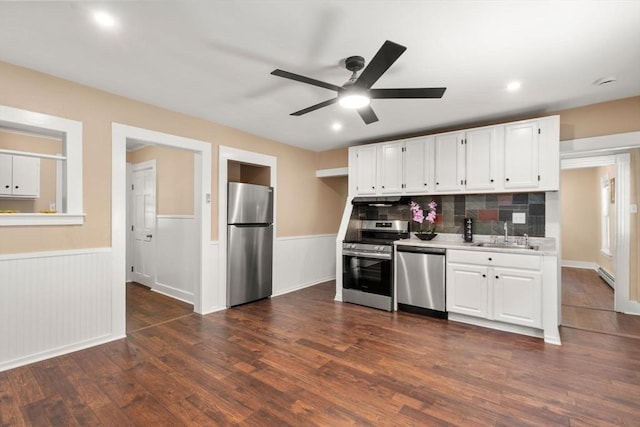 448 Washington St, Warren, MA 01083 - kitchen featuring stainless steel appliances, light countertops, white cabinets, a ceiling fan, and wainscoting