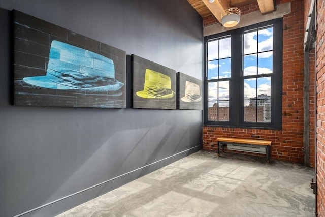 spare room featuring beam ceiling and brick wall