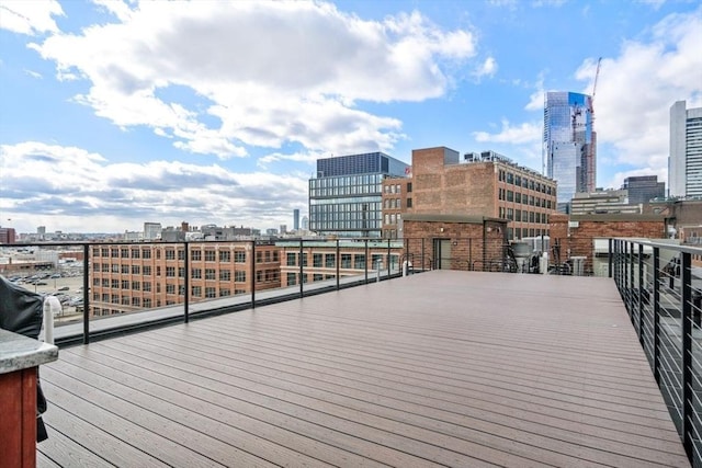 wooden terrace featuring a city view