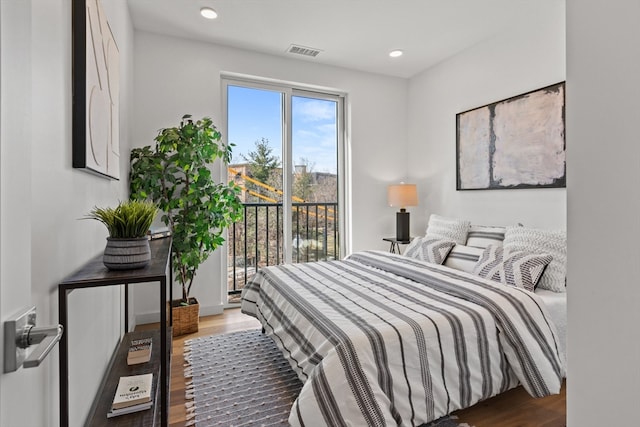 bedroom featuring wood-type flooring and access to exterior