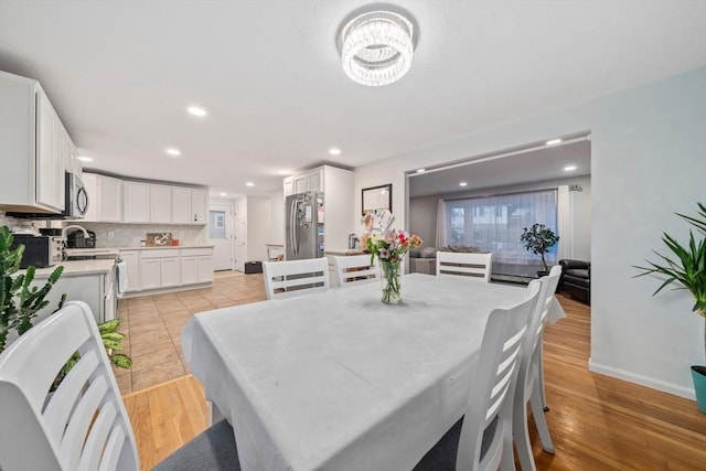 dining area featuring sink and light hardwood / wood-style floors