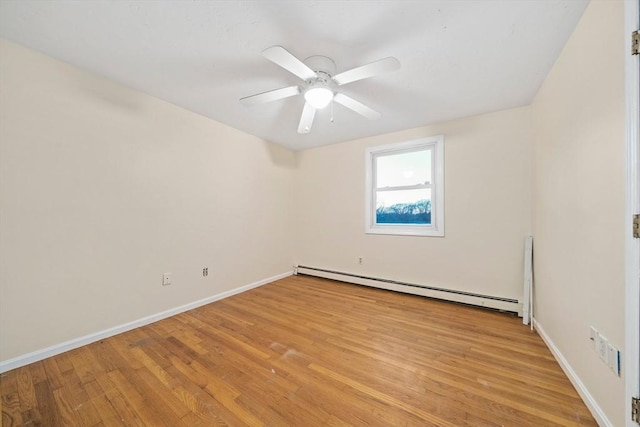 empty room with ceiling fan, baseboard heating, and light hardwood / wood-style floors