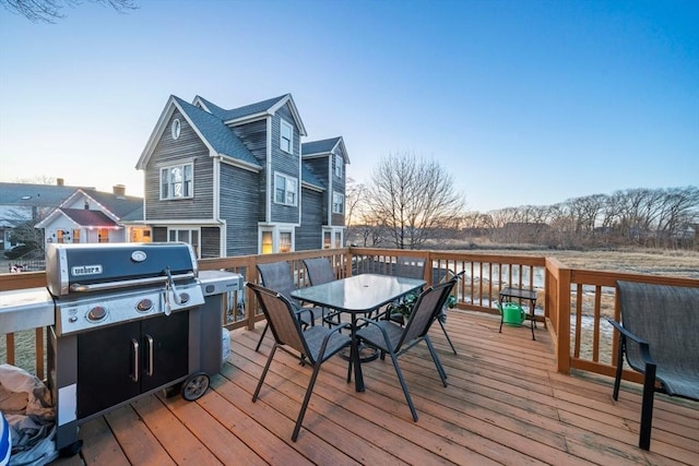 deck featuring a water view and a grill