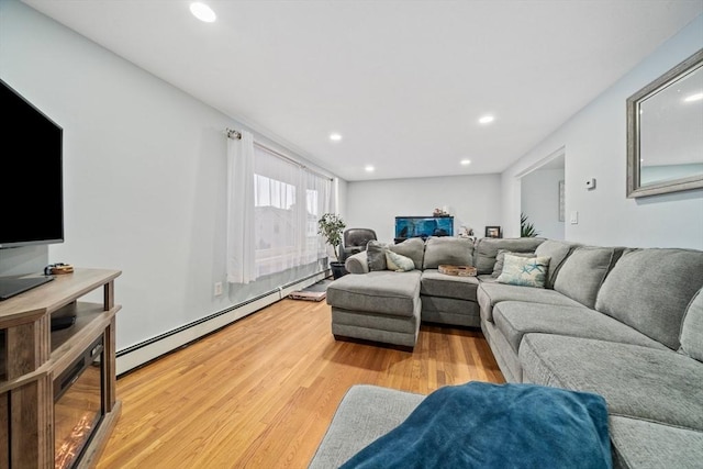 living room with a baseboard radiator and light hardwood / wood-style floors