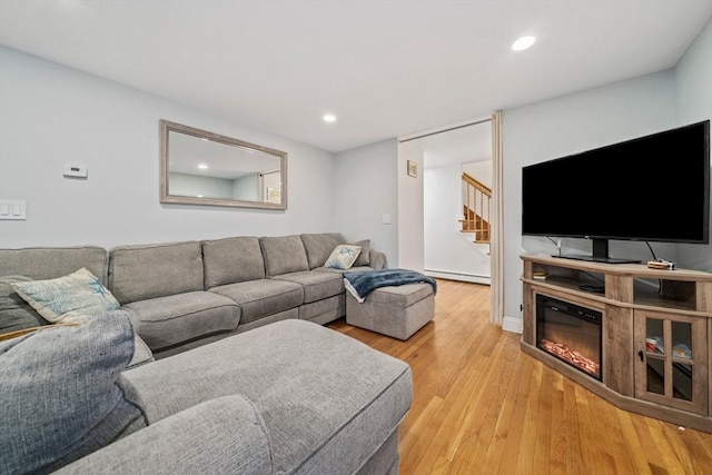 living room featuring light hardwood / wood-style flooring and a baseboard heating unit