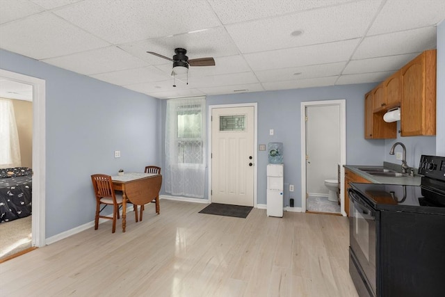 37 Thurston Ave Unit 37, Northbridge, MA 01588 - kitchen featuring black electric range, a sink, light wood-style floors, a drop ceiling, and a ceiling fan
