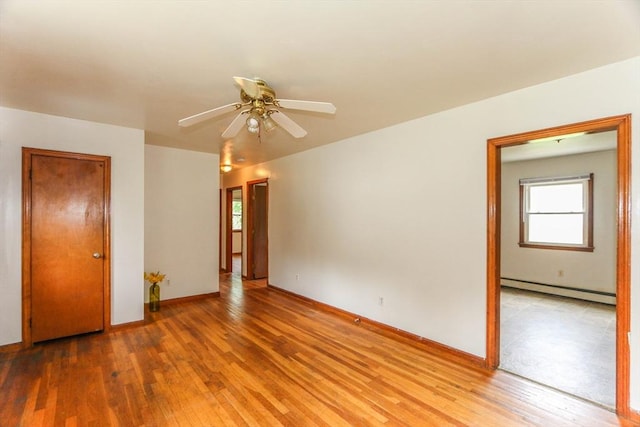109 Bacon Rd, Springfield, MA 01119 - empty room with a baseboard heating unit, light wood-style floors, and a ceiling fan