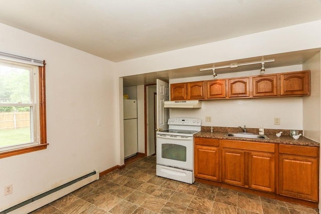 109 Bacon Rd, Springfield, MA 01119 - kitchen with white appliances, under cabinet range hood, a baseboard radiator, brown cabinetry, and dark countertops