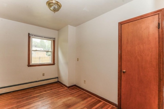 109 Bacon Rd, Springfield, MA 01119 - unfurnished room with a baseboard heating unit and wood finished floors