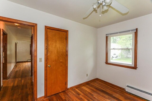 109 Bacon Rd, Springfield, MA 01119 - unfurnished bedroom with baseboard heating, dark wood-style floors, and ceiling fan
