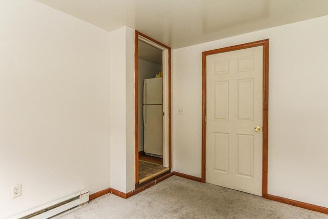 109 Bacon Rd, Springfield, MA 01119 - unfurnished bedroom featuring freestanding refrigerator, a baseboard radiator, and carpet