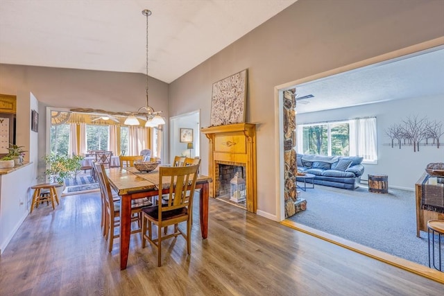 159 School St, Granby, MA 01033 - dining area with baseboards, wood finished floors, lofted ceiling, and a fireplace