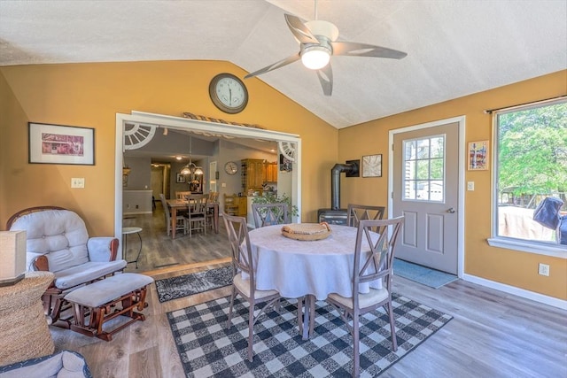 159 School St, Granby, MA 01033 - dining space with a wood stove, wood finished floors, vaulted ceiling, ceiling fan, and baseboards