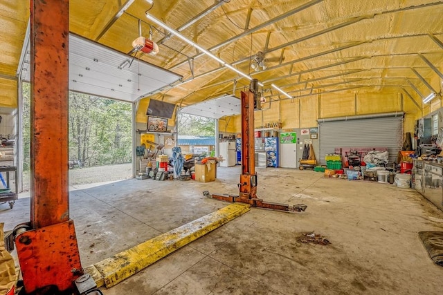159 School St, Granby, MA 01033 - garage featuring a garage door opener and freestanding refrigerator