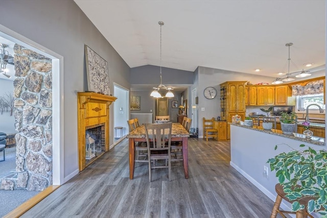 159 School St, Granby, MA 01033 - dining space with a chandelier, vaulted ceiling, dark wood-style flooring, and baseboards
