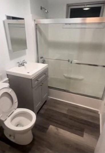 bathroom featuring vanity, hardwood / wood-style floors, and toilet