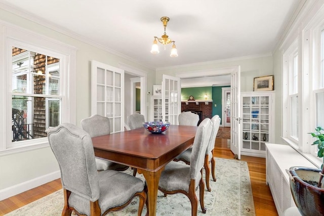 9 Palmer Rd, Marblehead, MA 01945 - dining area with a chandelier, light wood-type flooring, ornamental molding, french doors, and baseboards