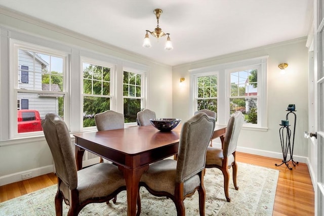 9 Palmer Rd, Marblehead, MA 01945 - dining space featuring a chandelier, crown molding, baseboards, and light wood-style floors