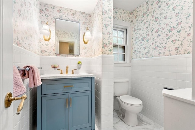 9 Palmer Rd, Marblehead, MA 01945 - bathroom featuring wallpapered walls, vanity, toilet, wainscoting, and marble look tiles