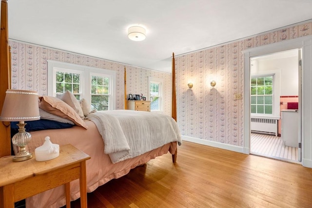 9 Palmer Rd, Marblehead, MA 01945 - bedroom featuring radiator heating unit, wallpapered walls, wood finished floors, and baseboards