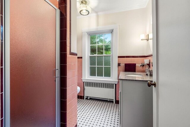 9 Palmer Rd, Marblehead, MA 01945 - bathroom with radiator, tile walls, vanity, a shower stall, and toilet
